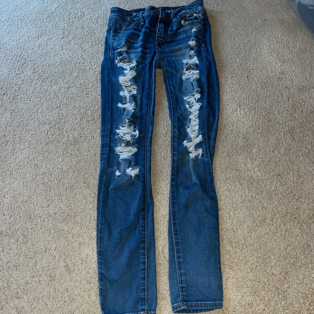 High-waisted, distressed blue denim skinny jeans
